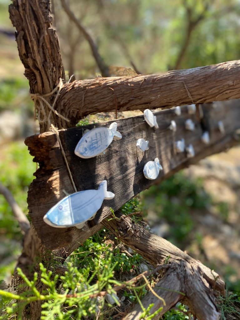 Ceramic fish on driftwood